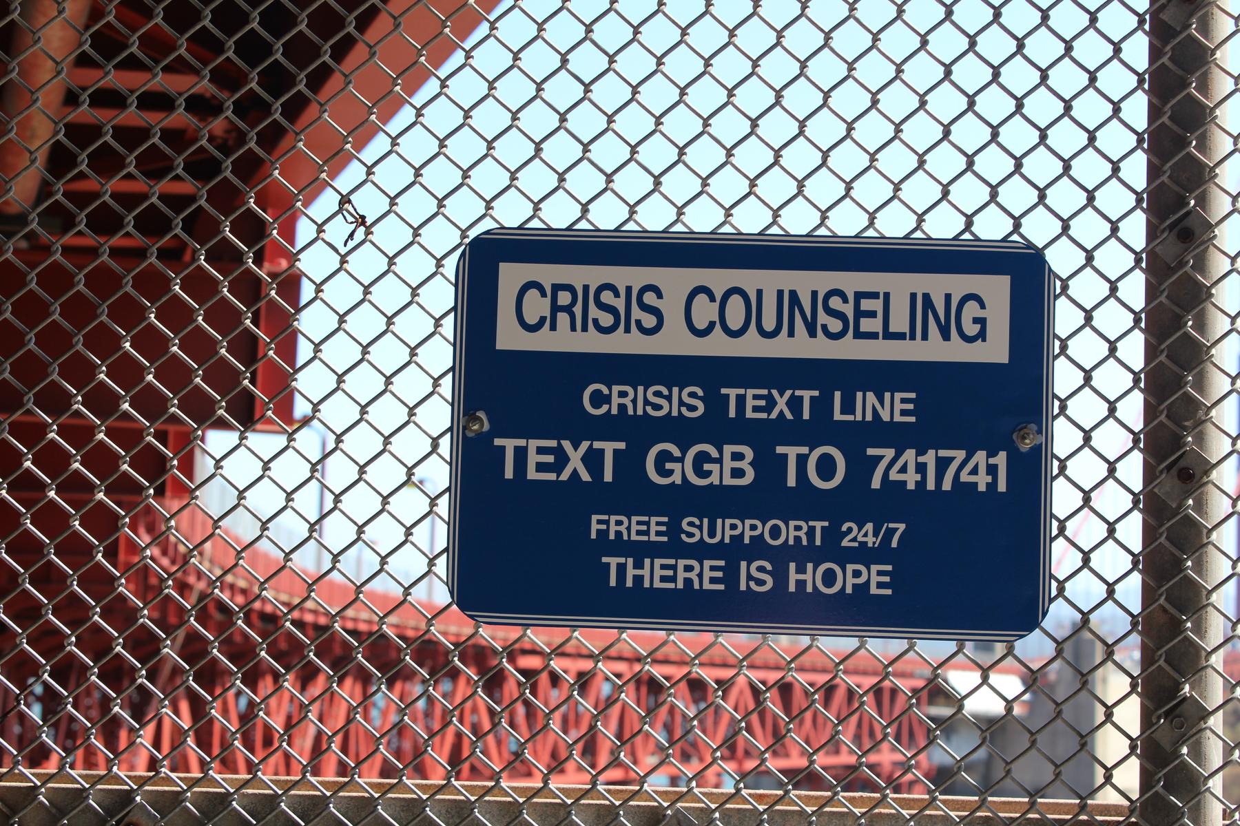 a sign on a fence - File:Crisis Counseling at Golden Gate Bridge.jpg
