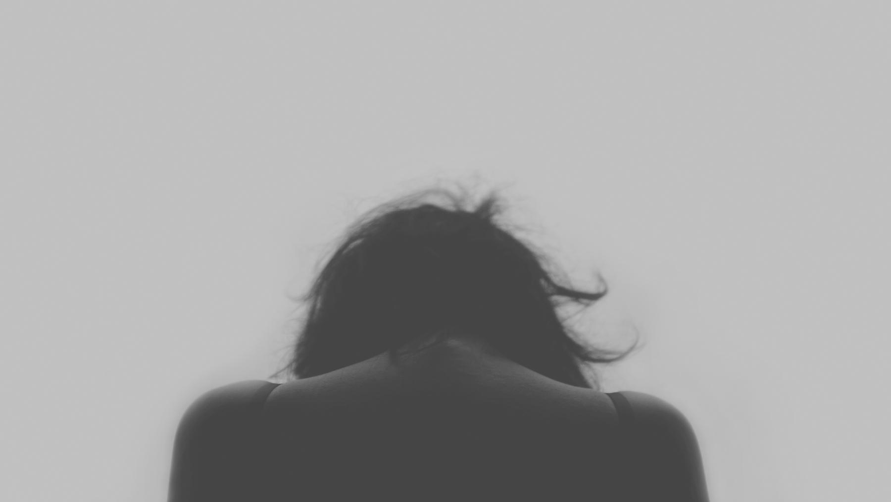 File:Figure 5. Anxiety can leave a person feeling extremely sad.jpg - a woman with her back to the c